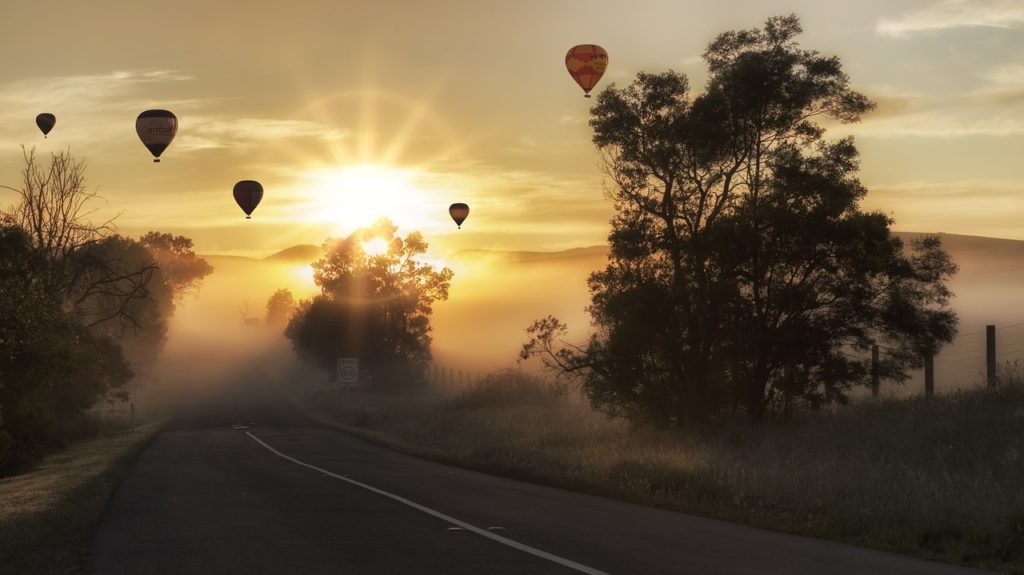 Hot Air Balloons Drifting over a Street