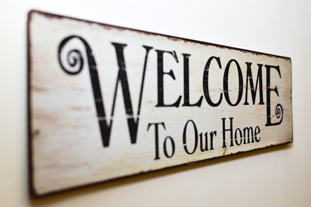 Black and white rustic style sign that says "welcome to our home."