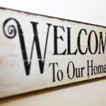 Black and white rustic style sign that says "welcome to our home."