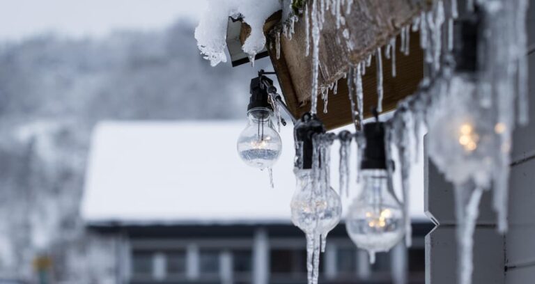 Ice and snow dripping from the roof of a home.