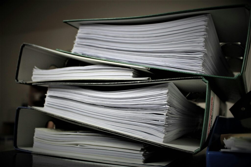 A stack of papers and documents that are often forgotten during a move