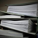 A stack of papers and documents that are often forgotten during a move